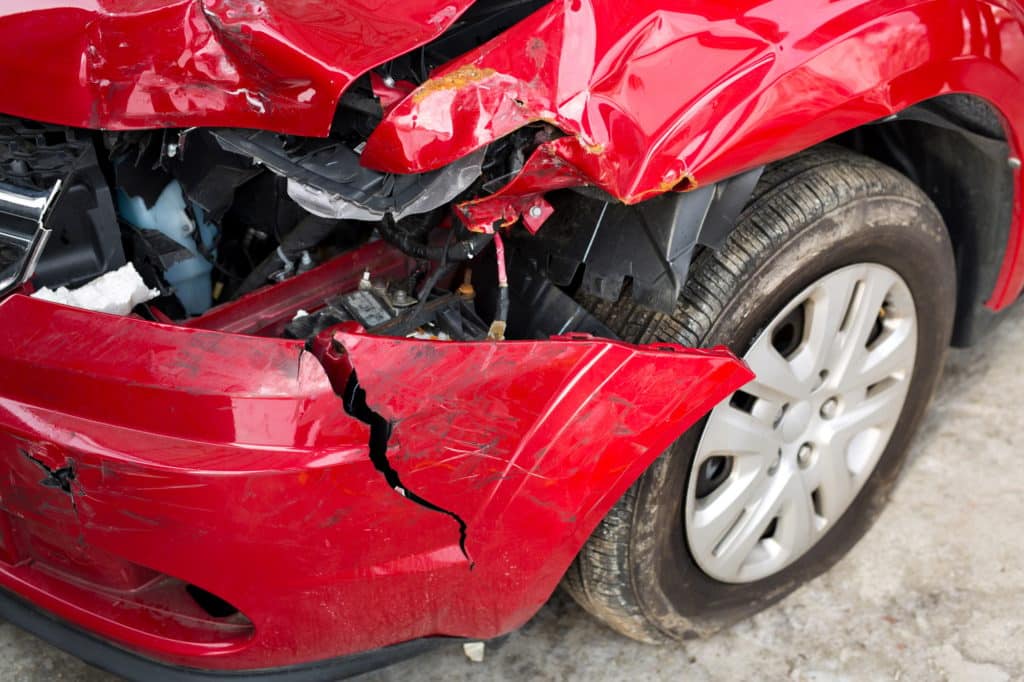 Red Car crash background. Front of red car get damaged by accident on the road