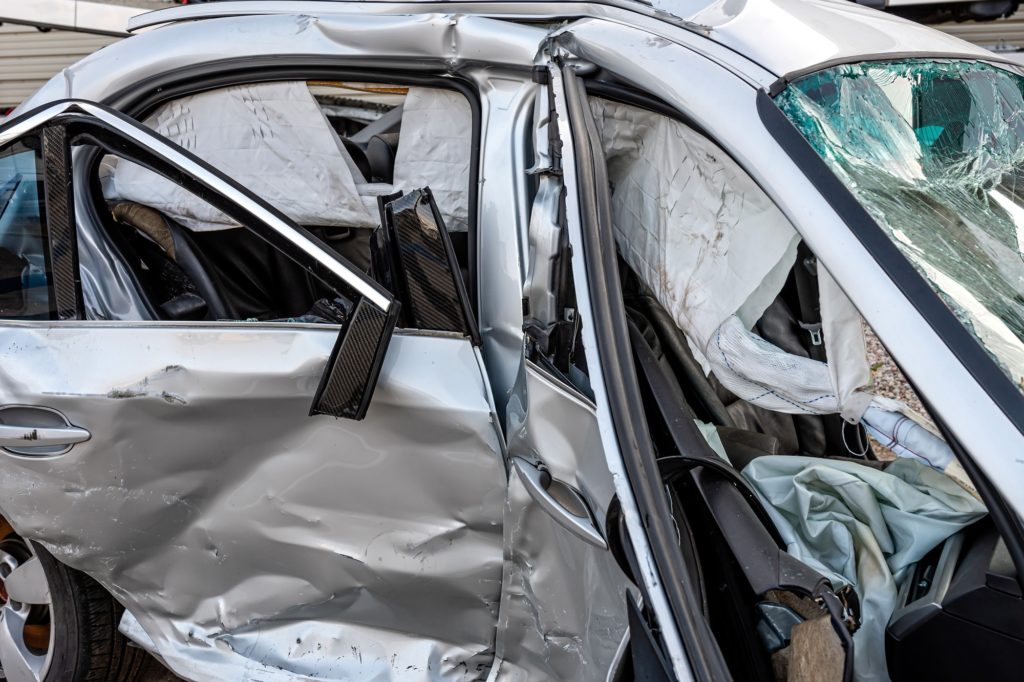 damaged vehicle closeup after a heavy crash, traffic accident, insurance concept